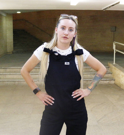 woman wearing YAYS unisex cotton dungaree in Raven Black, front view